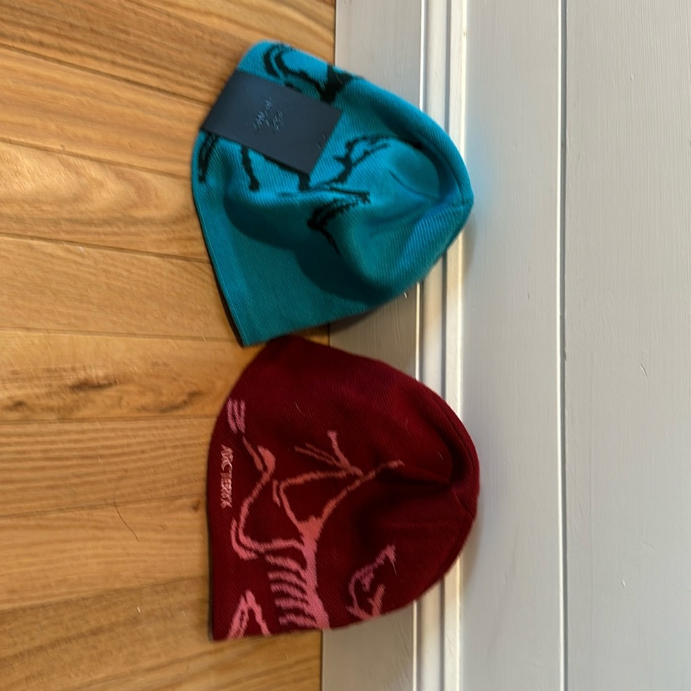 Two brand new hats with tags. One aqua blue and one maroon.